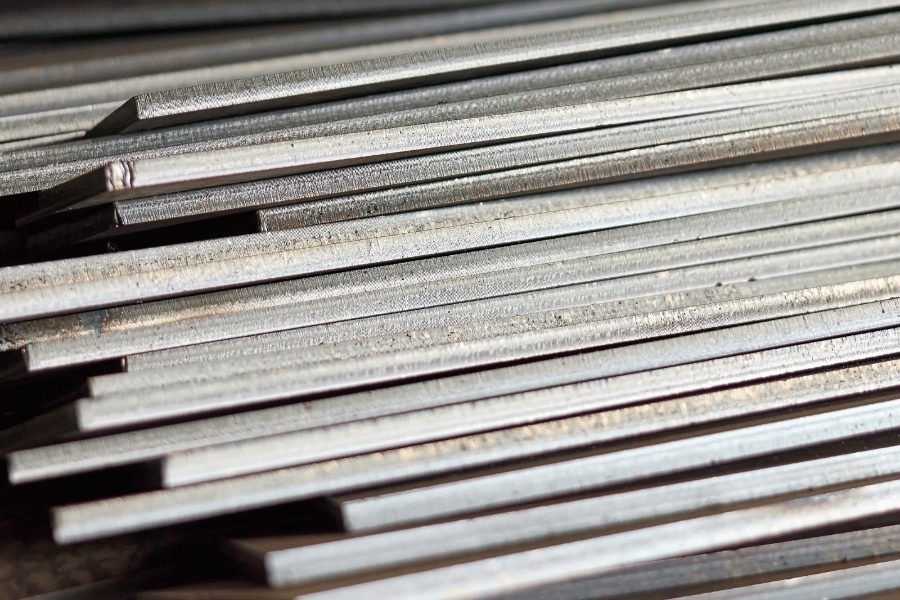 Stacked precision cut sheet metal bars used in CNC manufacturing