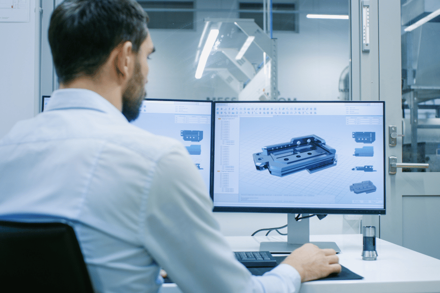 Engineer reviewing a CNC machined part design during prototype phase production